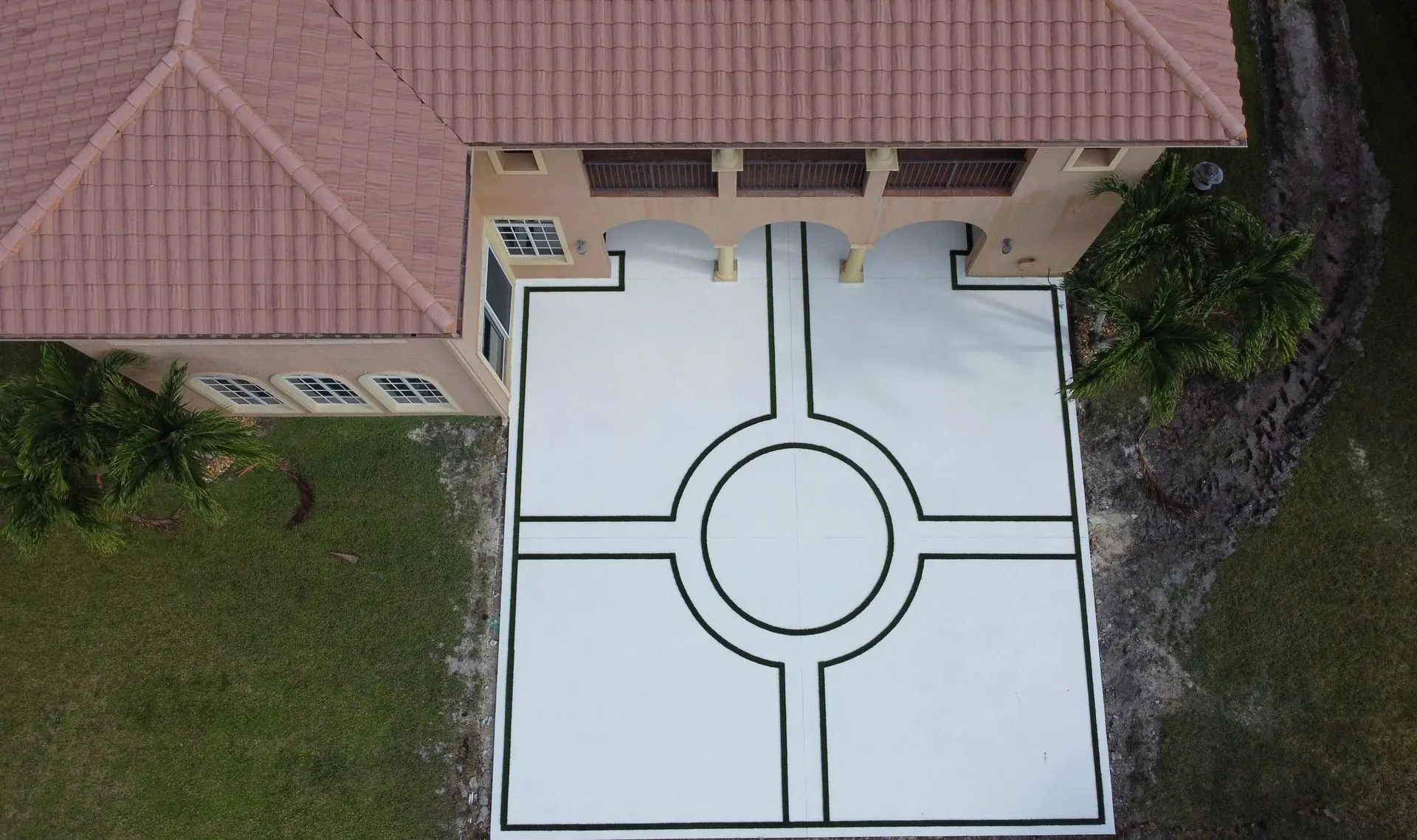 Custom geometric concrete patio with artificial grass in Parkland, Florida