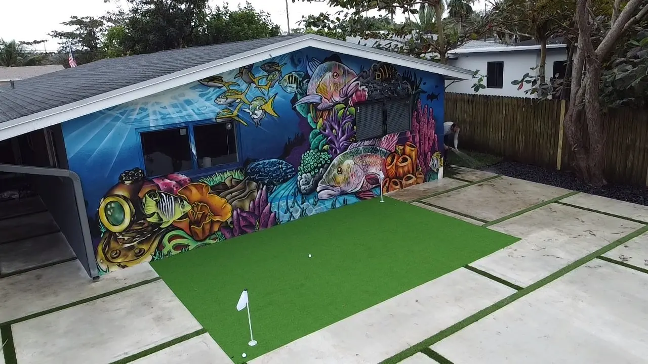 Backyard putting green with concrete and turf joints by Concrete Solutions Today, Broward County, FL