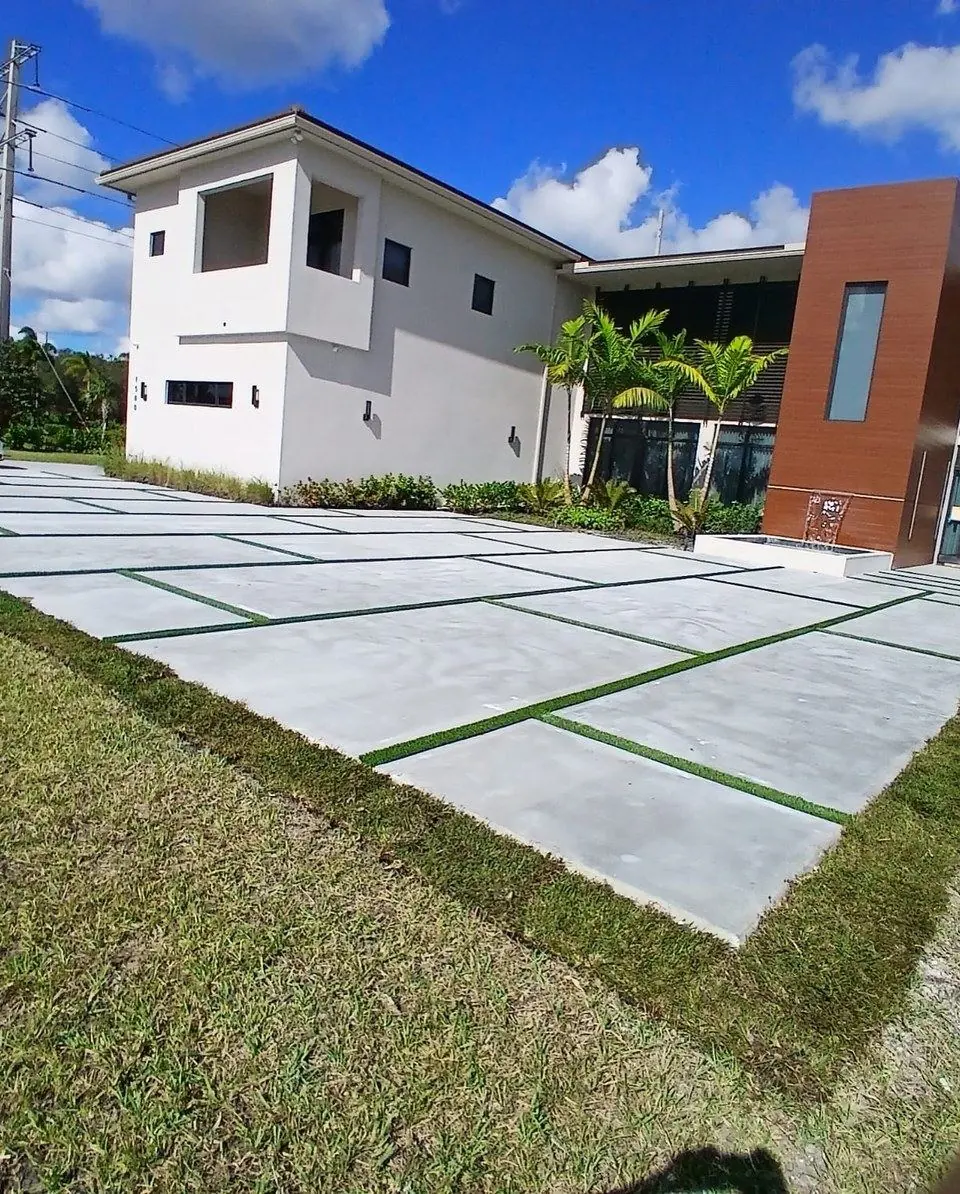 Concrete driveway panels with artificial grass joints by Concrete Solutions Today, Davie, FL
