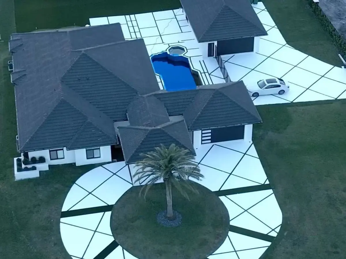Existing concrete upgraded with diagonal artificial grass lines, aerial view by Concrete Solutions Today, Davie, FL