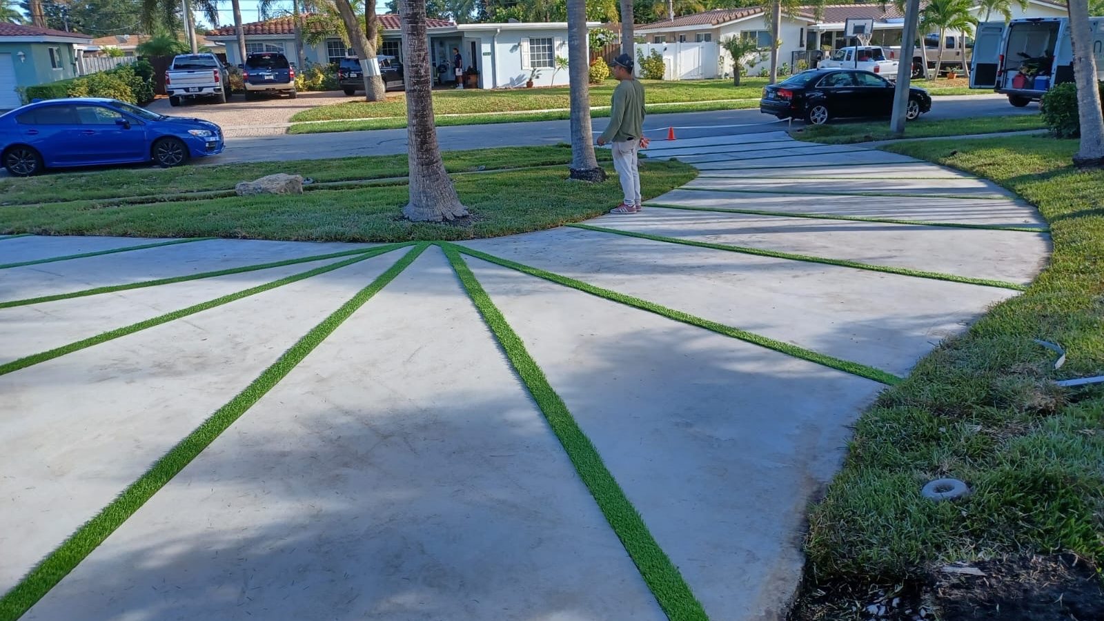 Sunburst-pattern concrete driveway with turf joints by Concrete Solutions Today, Fort Lauderdale, FL