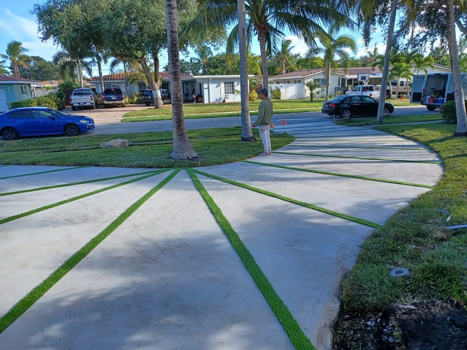 Sunburst-pattern concrete driveway with turf joints by Concrete Solutions Today, Fort Lauderdale, FL