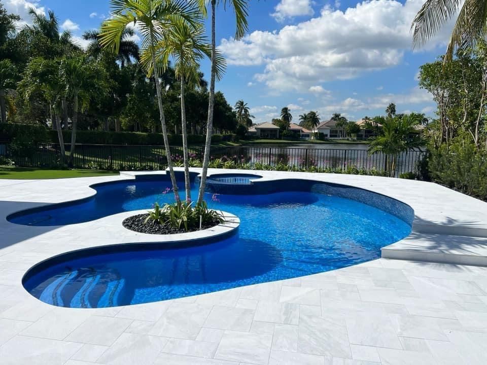 Freeform pool with a palm island and white deck, Broward County, Florida