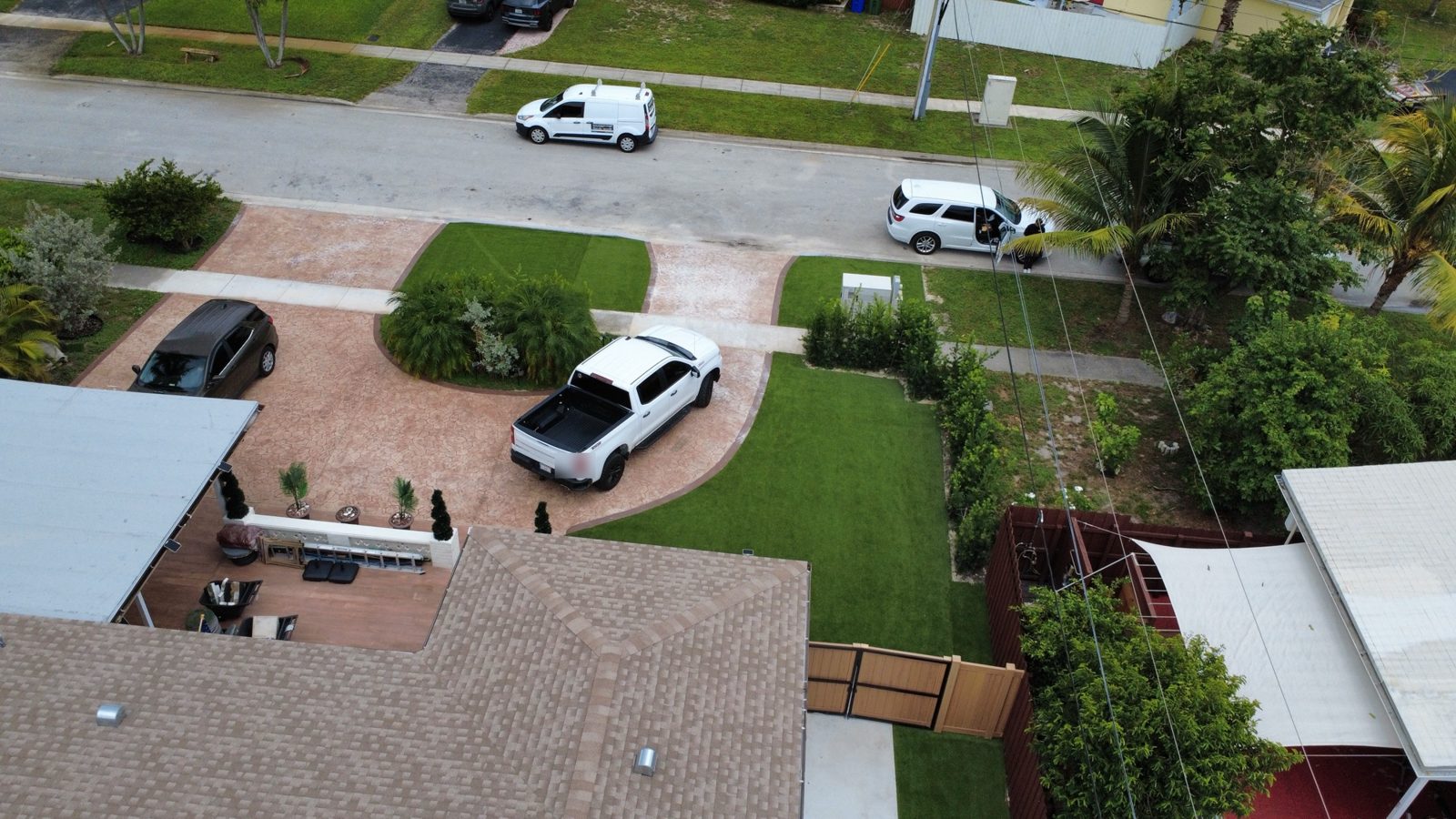 Front yard artificial turf lawn beside a stamped driveway, Broward County, Florida