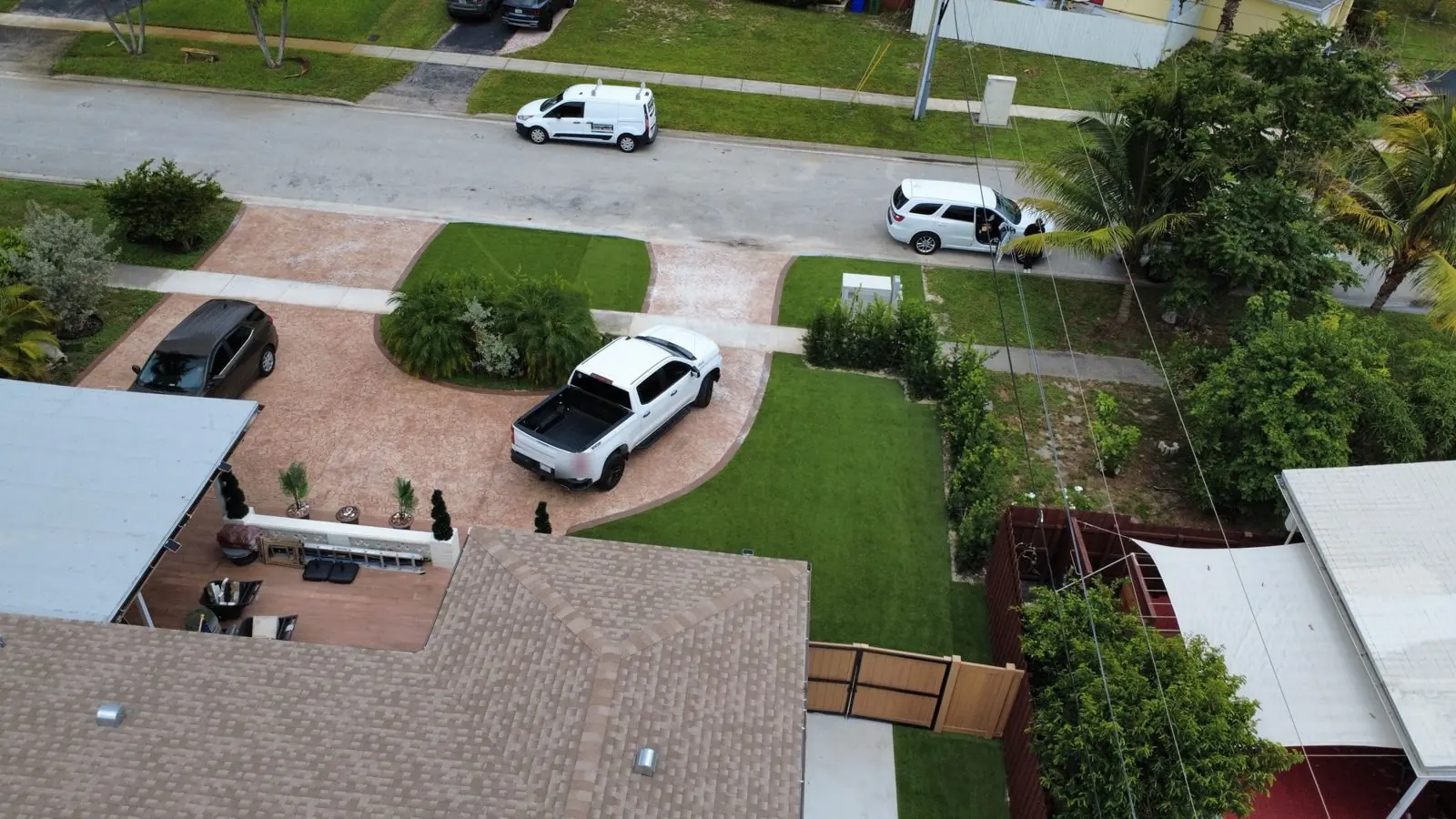 Front yard artificial turf lawn beside a stamped driveway by Concrete Solutions Today, Broward County, FL