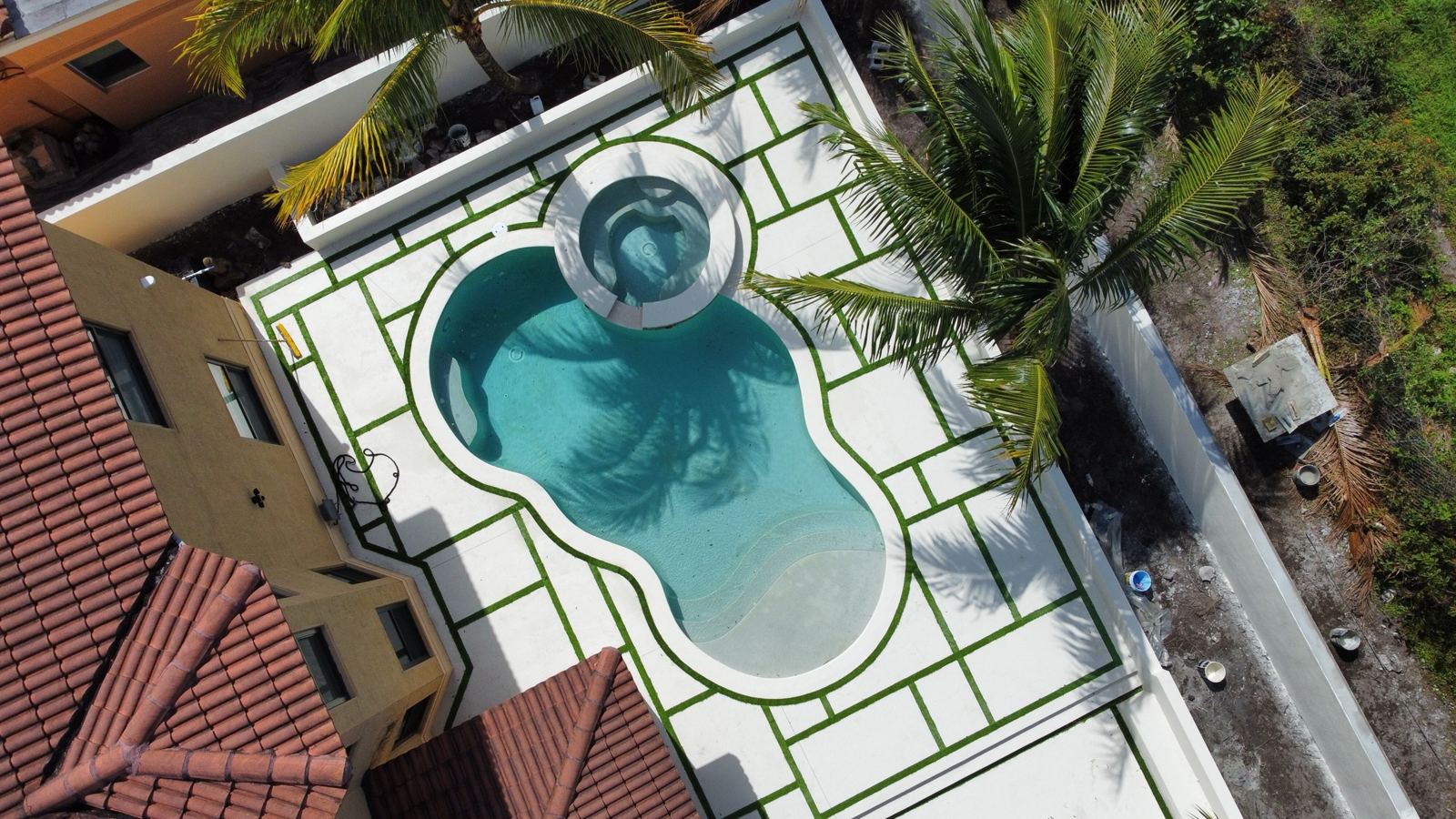 Freeform pool and spa with a stone deck, Plantation or Coral Springs, Florida