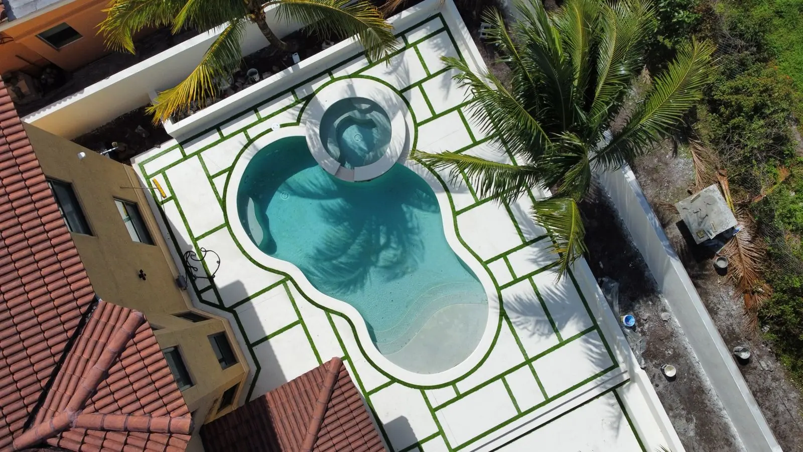 Freeform pool and spa with a stone deck, Plantation or Coral Springs, Florida