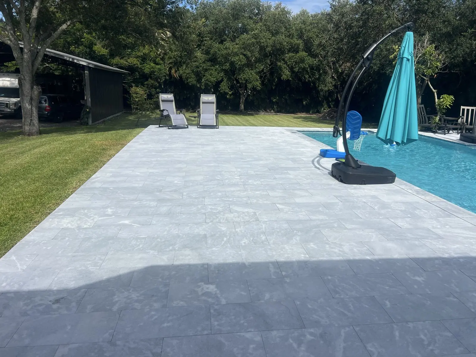 Large-format stone paver pool deck by Concrete Solutions Today, Broward County, FL