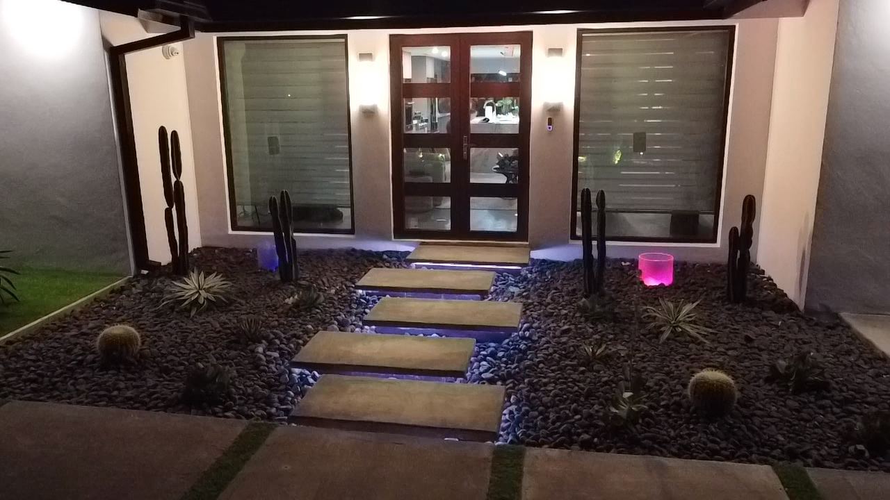 Modern home entry with lit floating concrete steps