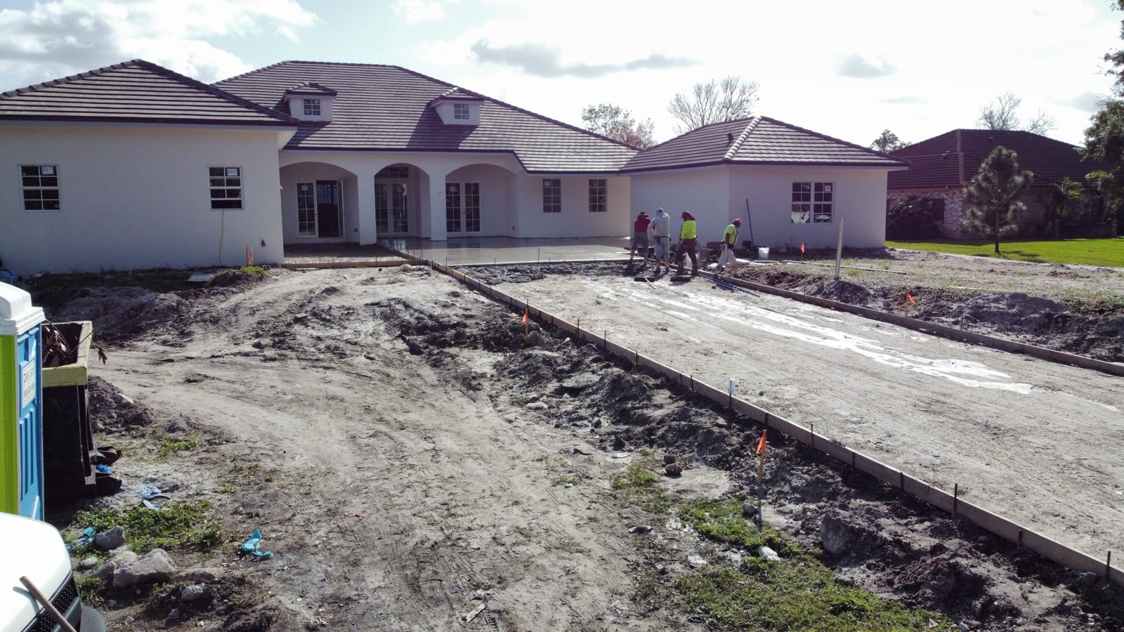 Crew finishing the driveway pour inside the forms by Concrete Solutions Today, Parkland, FL