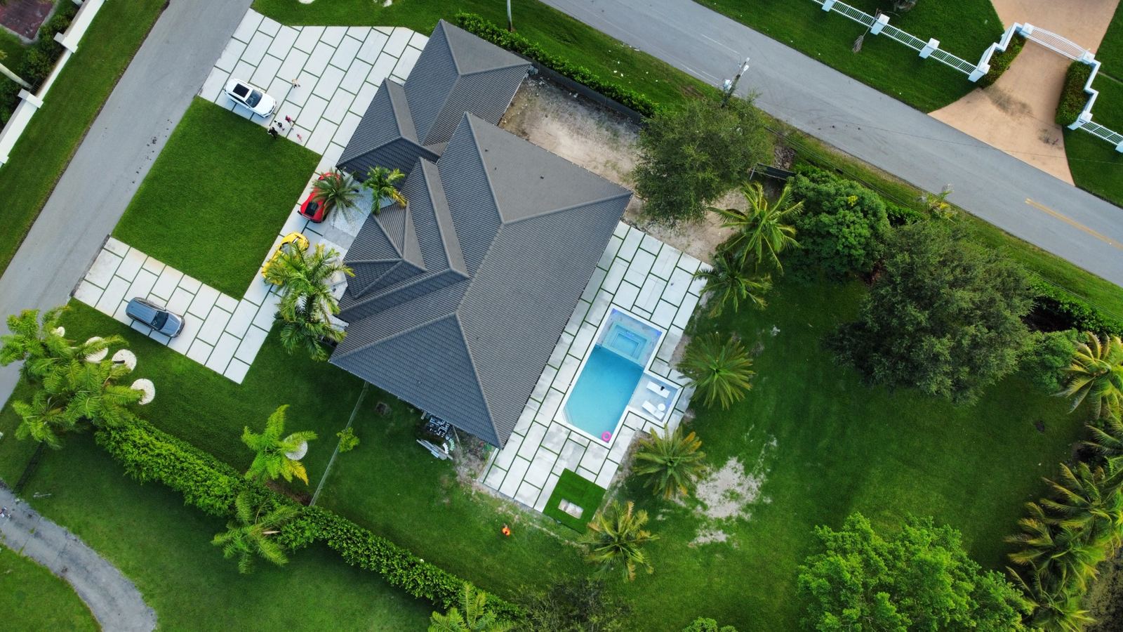 Pool deck with concrete slabs beside the home, aerial view, Plantation or Coral Springs, Florida
