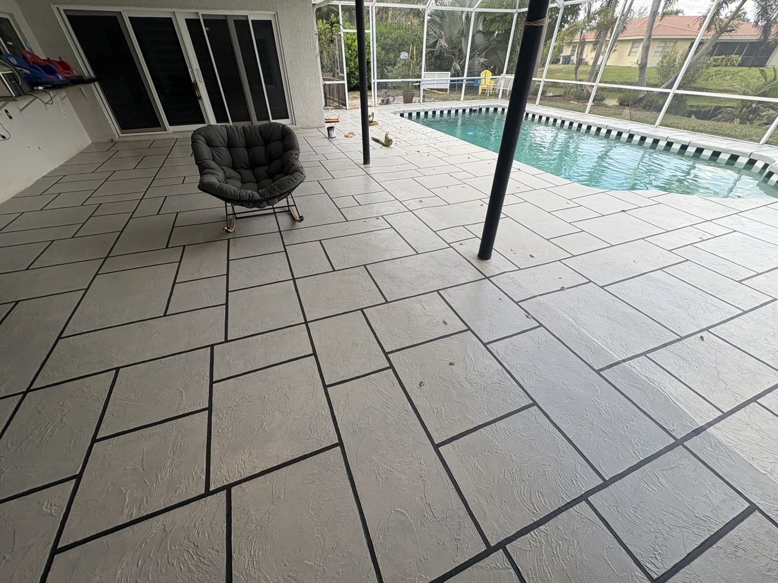 Pool deck inside a screen enclosure in Broward County