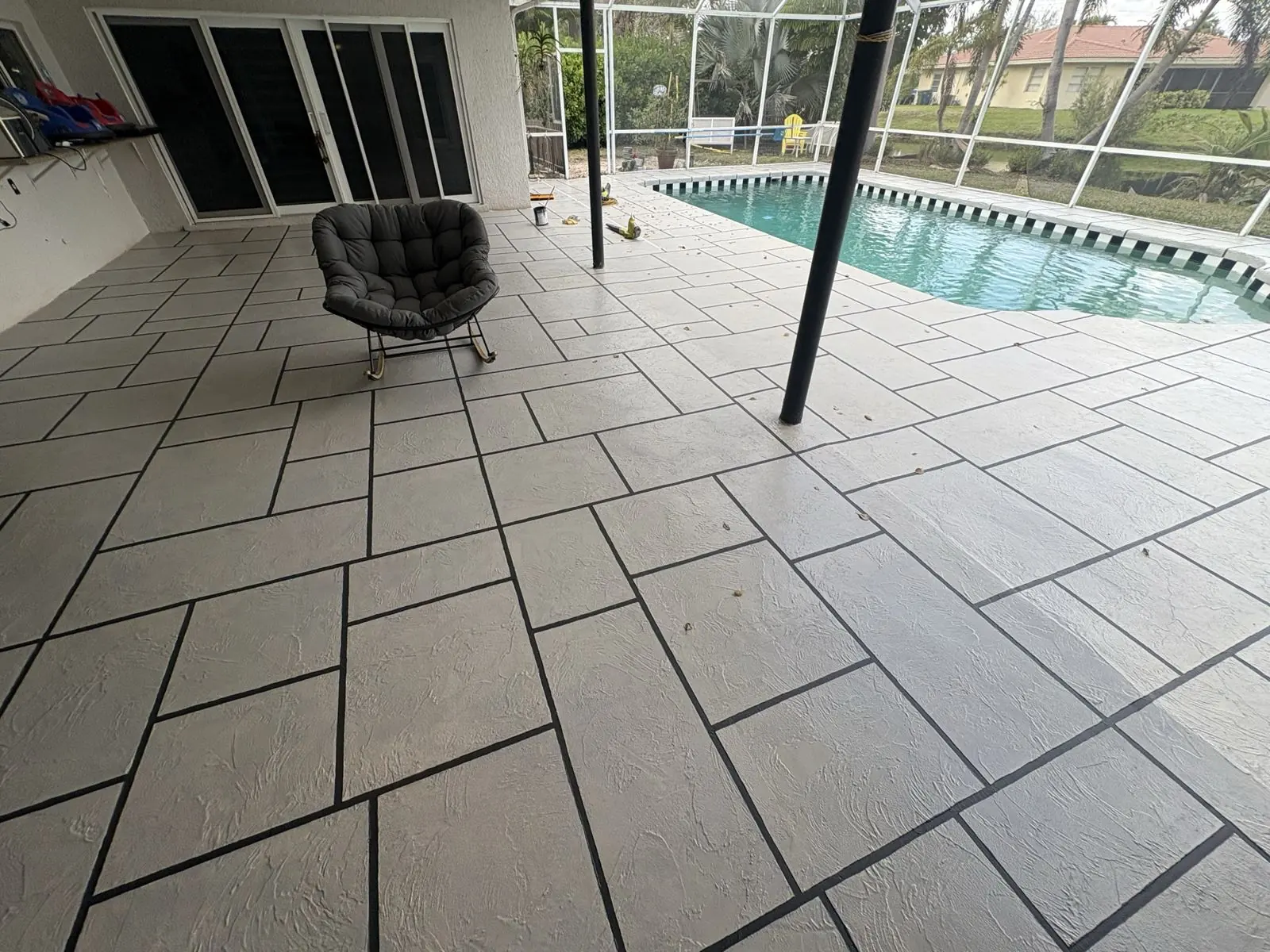 Resurfaced pool deck inside a screen enclosure by Concrete Solutions Today, Broward County, FL
