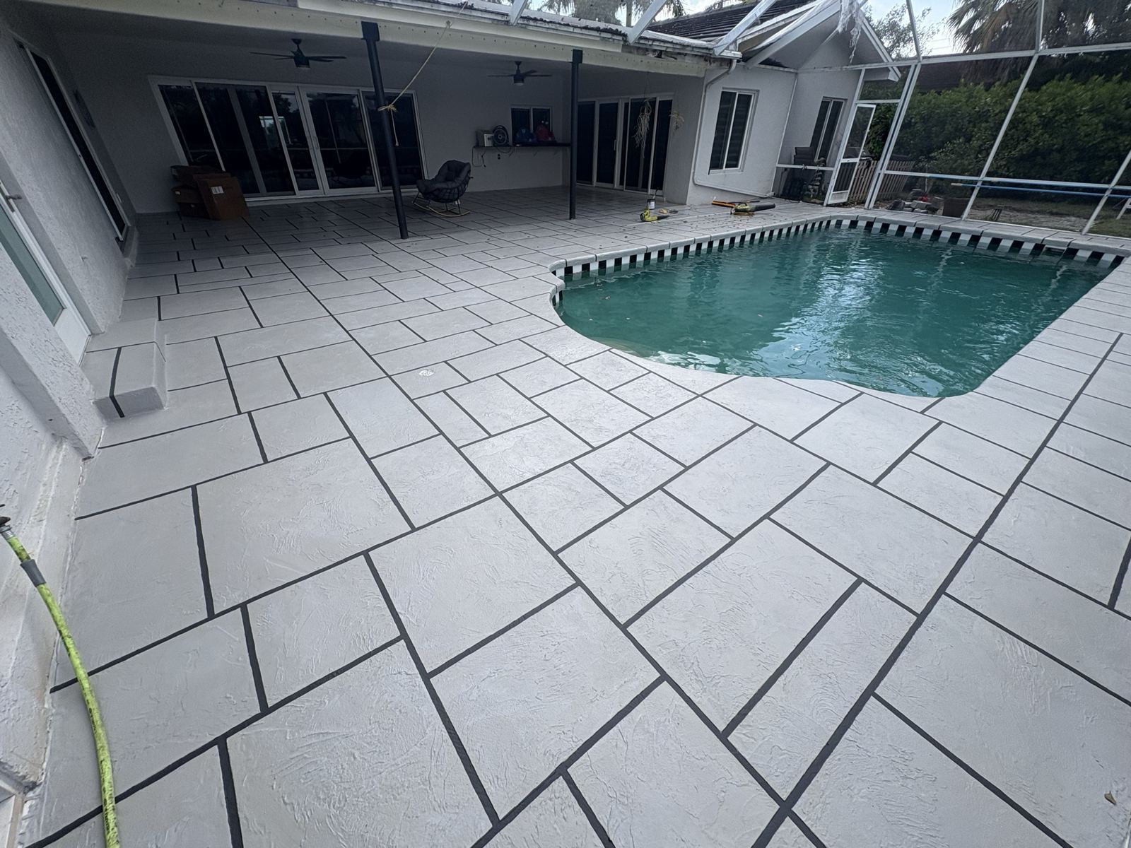 Resurfaced pool deck with a tile-pattern finish, Broward County, Florida
