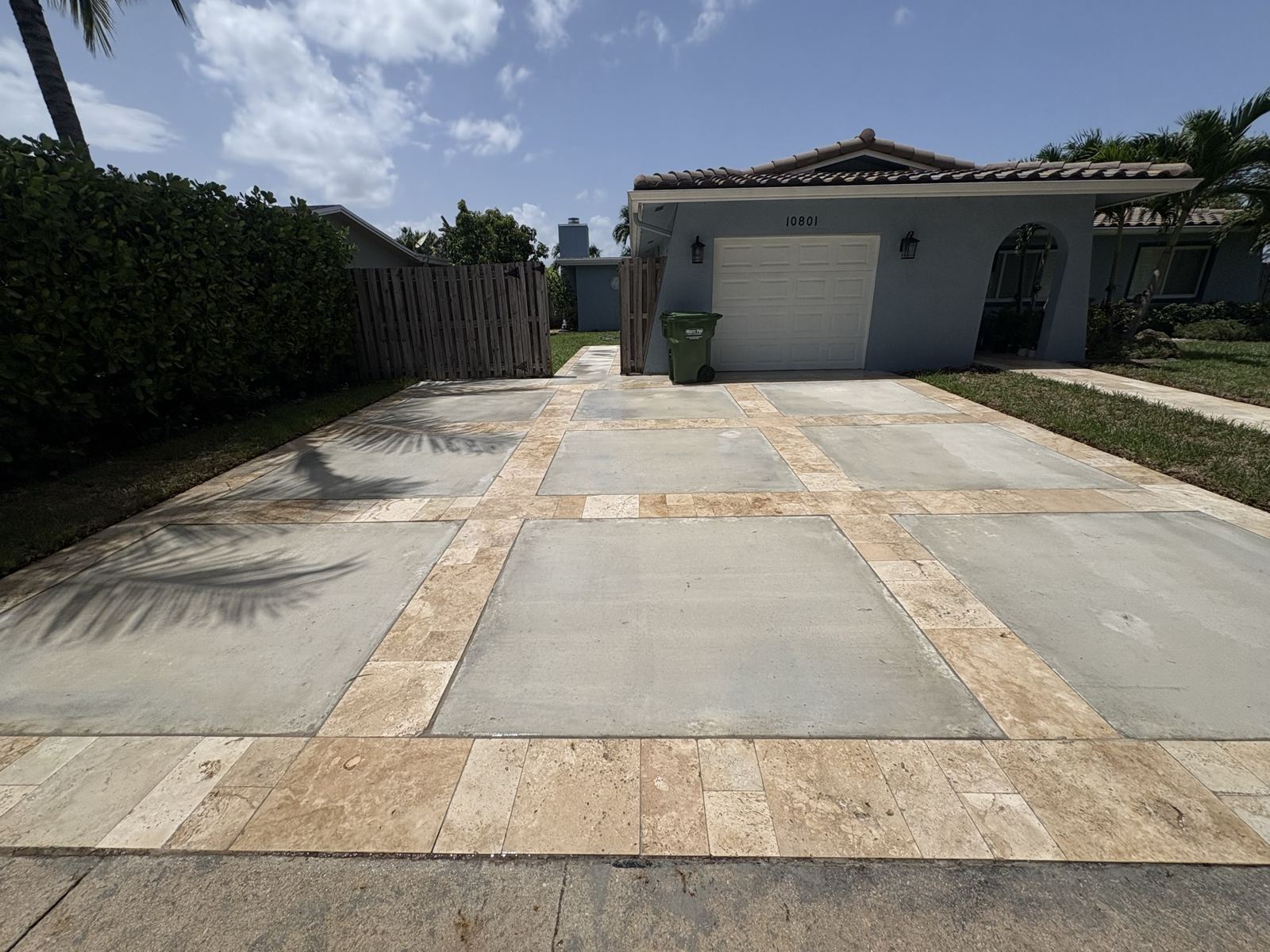 Driveway with travertine-style paver borders by Concrete Solutions Today, Broward County, FL