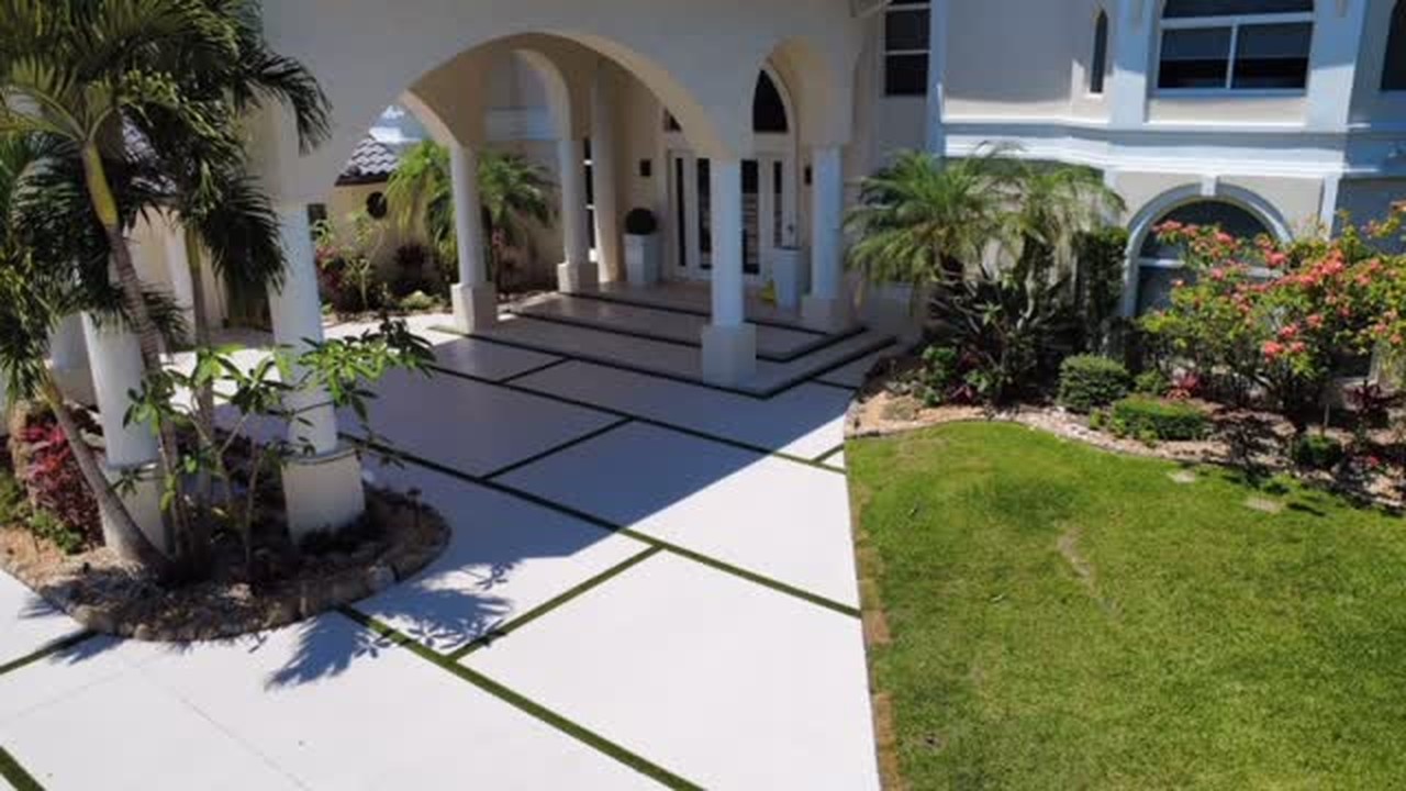 Modern concrete driveway with 8 by 16 foot artificial grass rectangles at a Weston home built by Concrete Solutions Today