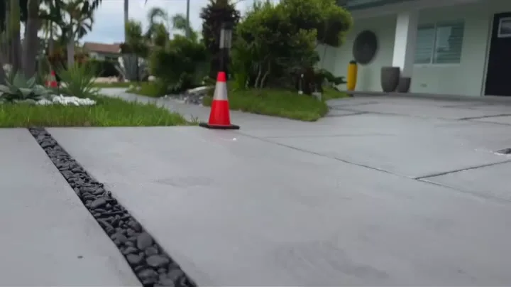 Close-up of a black rock joint between concrete driveway panels by Concrete Solutions Today, Wilton Manors, FL