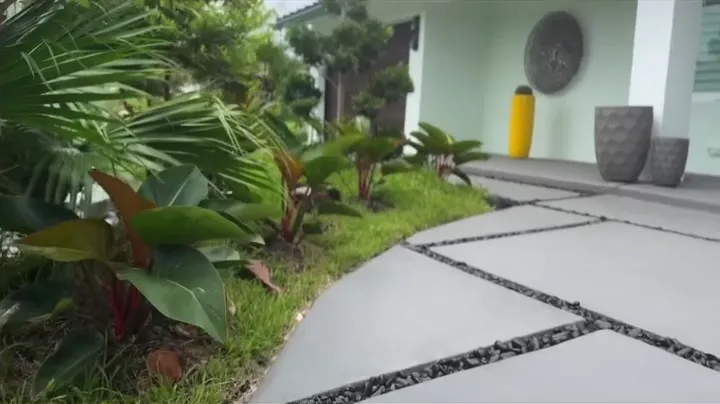 Concrete walkway slabs with black rock joints leading to the front entry by Concrete Solutions Today, Wilton Manors, FL